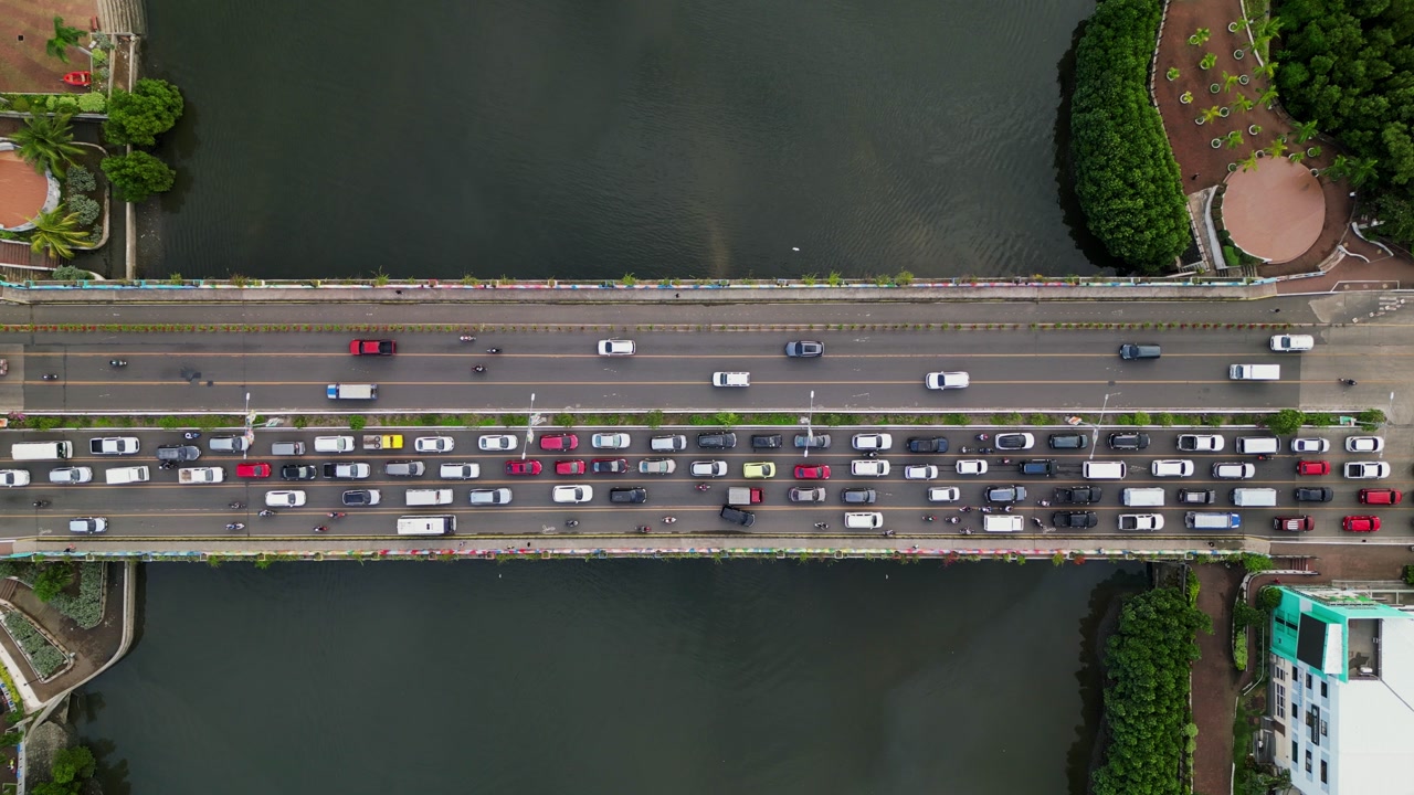 A busy bridge in Iloilo City with heavy traffic over a river, showcasing urban congestion. Ideal for projects on transportation, city life, or infrastructure.
