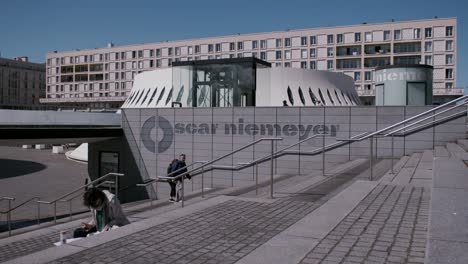 modern urban building entrance with oscar niemeyer signage