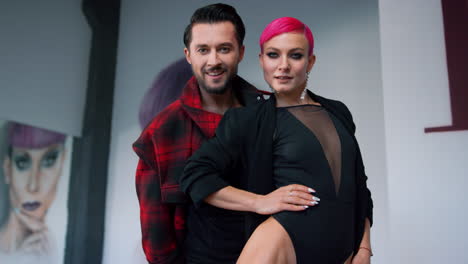 People-dancing-in-modern-hall.-Attractive-dancers-posing-camera-indoors.