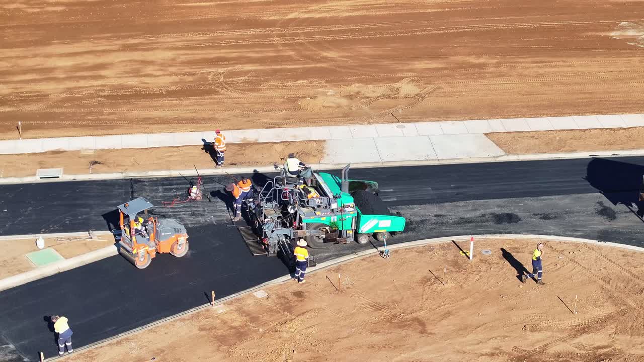 Road Construction Crew Paving Asphalt on a New Road