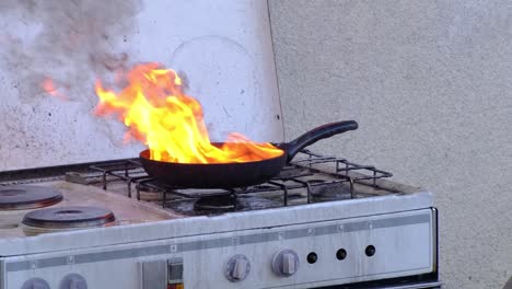 Fat-burning-in-pan-on-a-stove-in-the-kitchen,-kitchenfire-demonstration