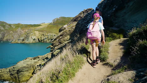 family hiking on coastal trail