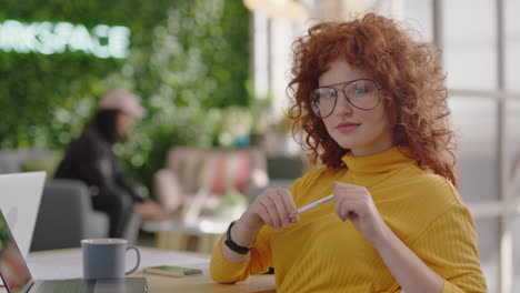portrait beautiful young redhead business woman smiling happy entrepreneur enjoying successful career in trendy startup office wearing glasses