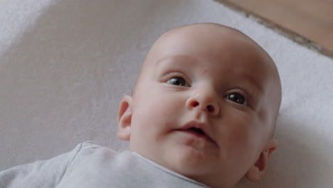 portrait beautiful baby looking curious infant lying on blanket