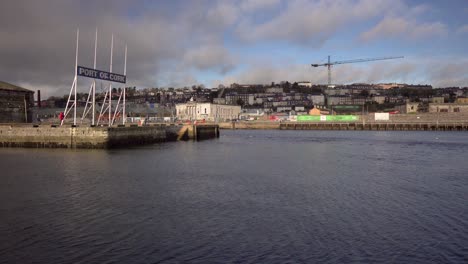 Static-shot-of-port-of-Cork-and-river-Lee-flowing-with-dramatic-moving-clouds-on-a-sunny-morning-in-Ireland,-Cork