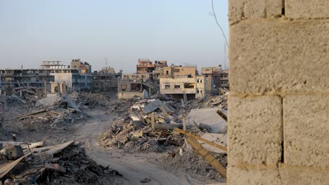 establishing war footage of ruined palestinian city destroyed buildings, view through the window