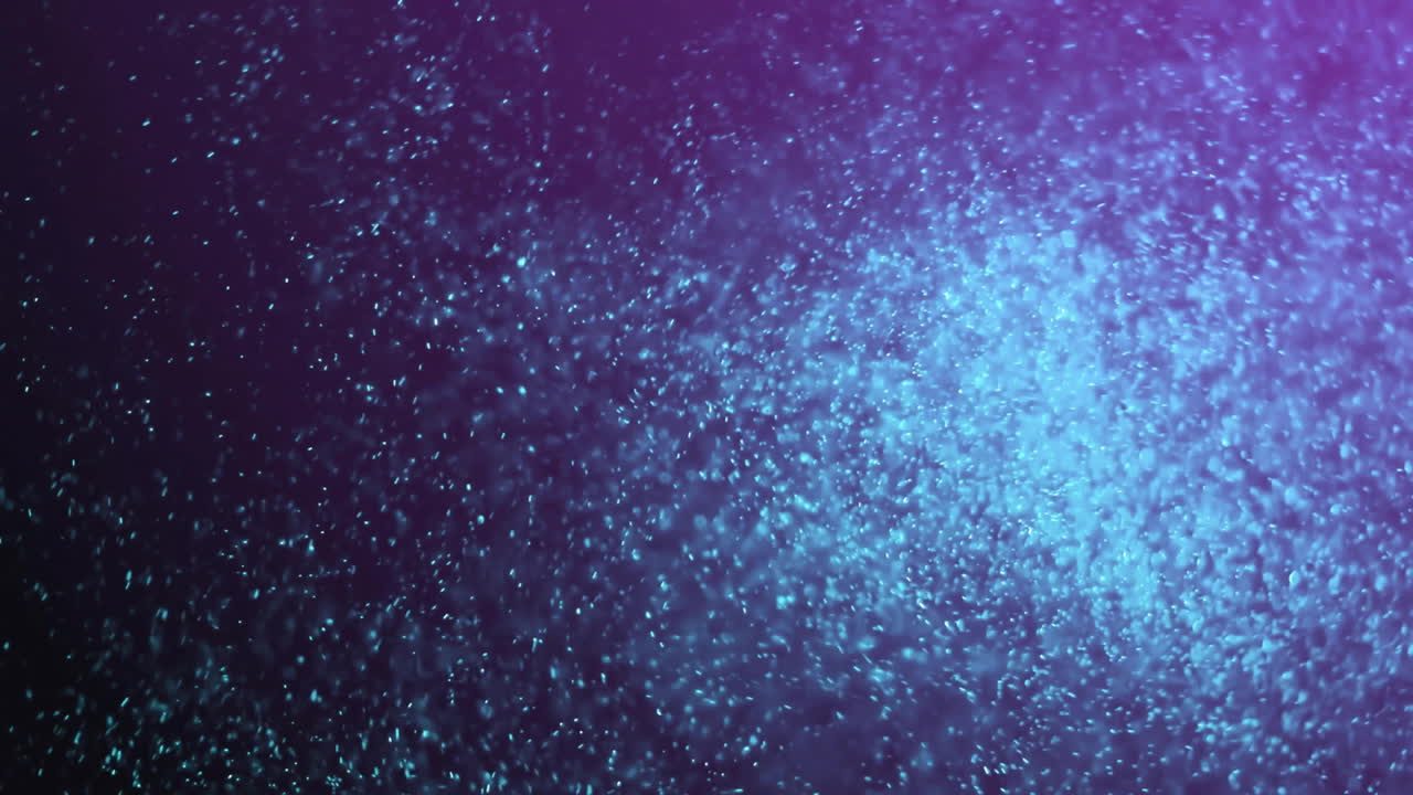 Animation af glødende lyspletter bevægende sig over sort baggrund