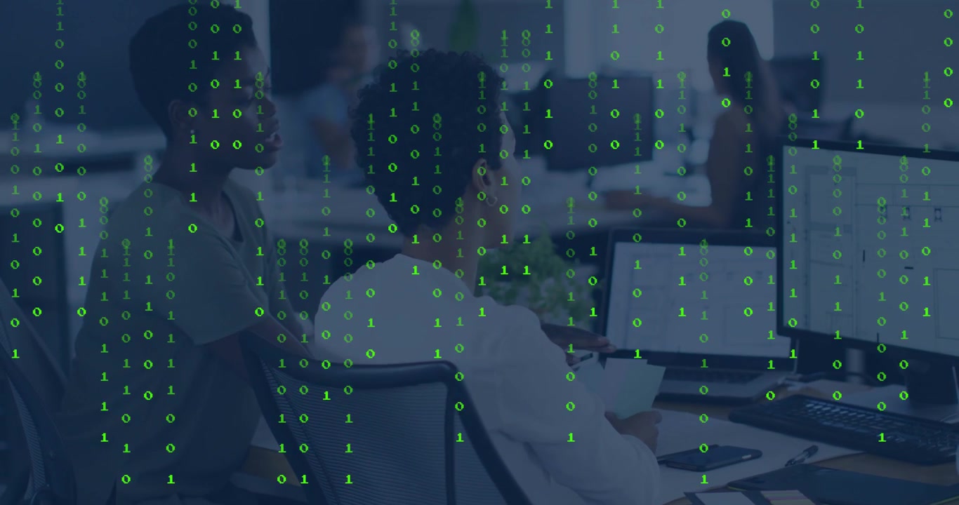 Seated woman analyzing grid in tech as binary overlay appearing, leaning woman pointing at screen