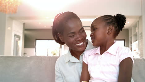 Mother-and-daughter-sitting-on-couch