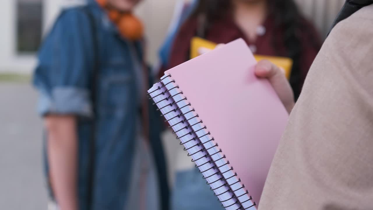 three unrecognizable student girls talking during class breaks