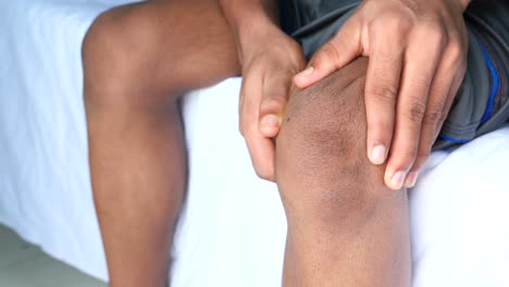 man holding his painful knee