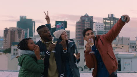 happy group of friends posing for selfie photo enjoying rooftop party celebration having fun drinking wine sharing weekend in city on social media