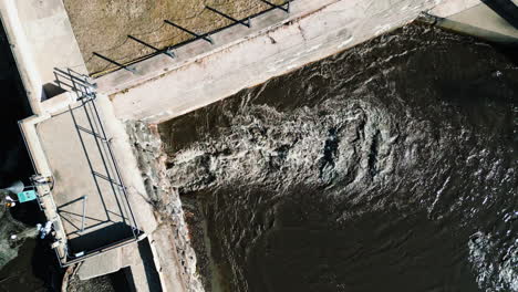 elevated view of sediment-laden water flowing through a river