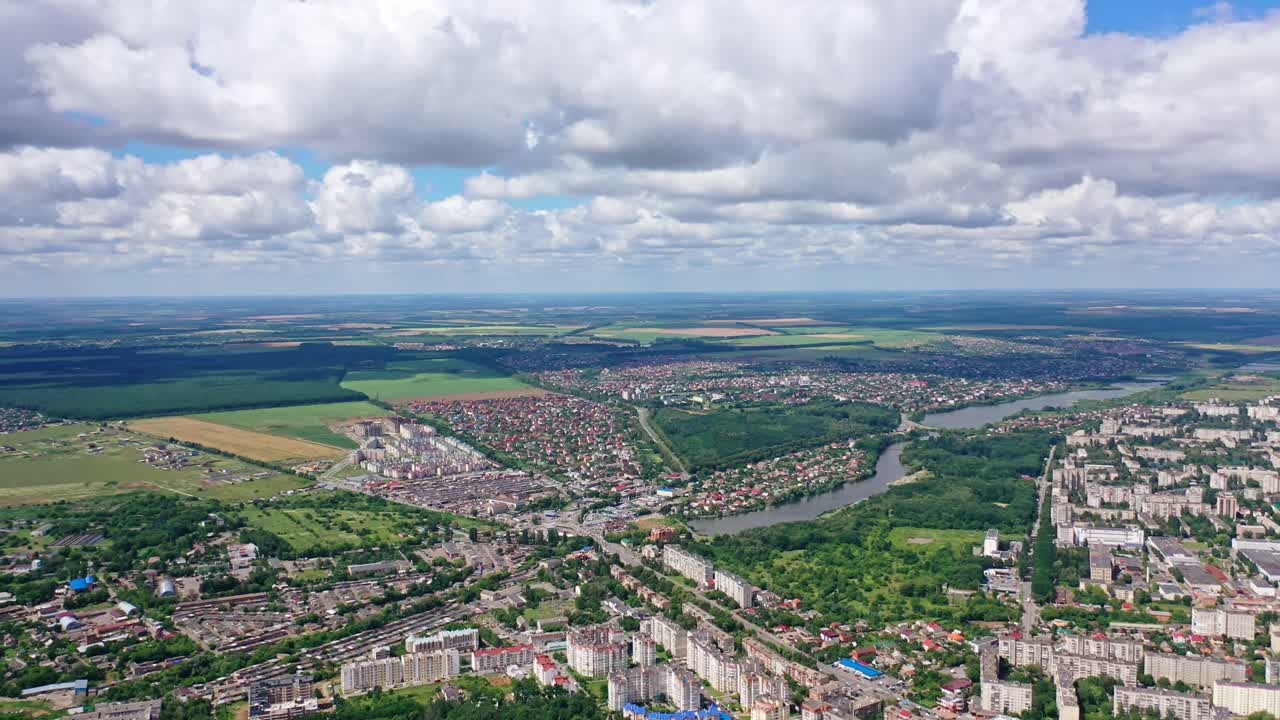 City landscape in summer. River flowing in the city. View from above on the city on the beautiful nature background. Aerial view.