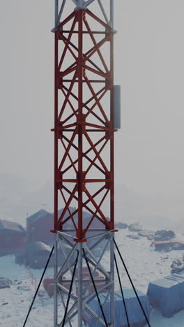 red communication tower in a snowy landscape