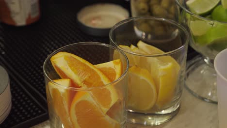 close-up shot of freshly cut oranges, lemon and limes ready for garnishing drinks