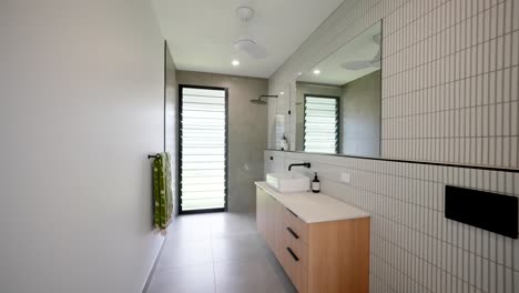 modern tropical home bathroom with sleek finishes, natural lighting, and contemporary design for a relaxing experience