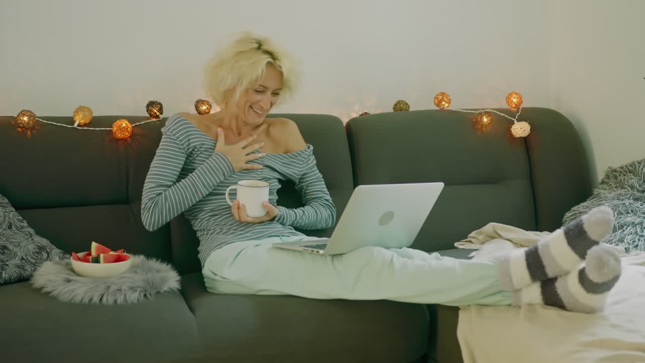Woman having a video call on a couch