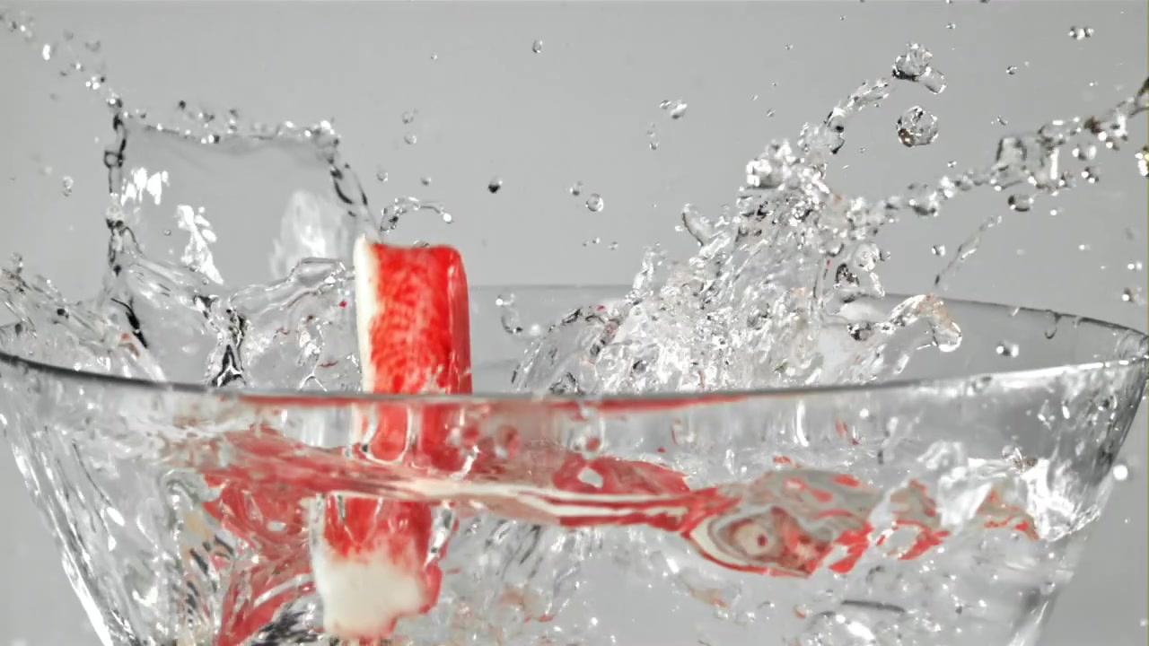 Red and White Crab Sticks Splashing into Clear Water