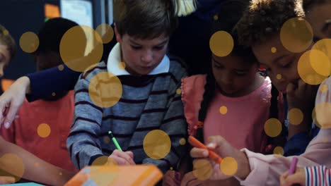 Animation-of-yellow-spots-over-diverse-schoolchildren-drawing-with-teacher