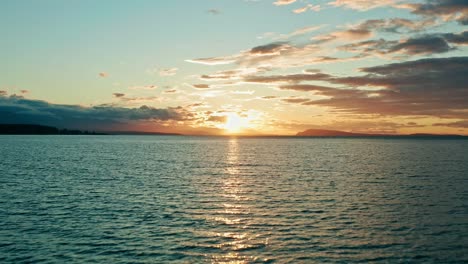 Aerial-Fly-Over-of-Beautiful-Sunset-Over-Water---Calm-and-Relaxing---Golden-Hour-Background