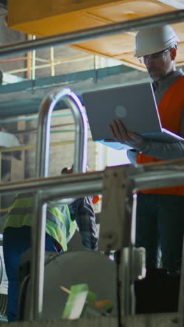 industrial workers collaborating on machinery maintenance