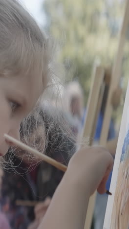 young girl painting outdoors