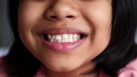 child smiling with healthy white teeth