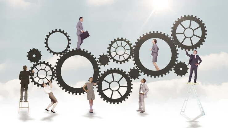 Business people running and turning cogs