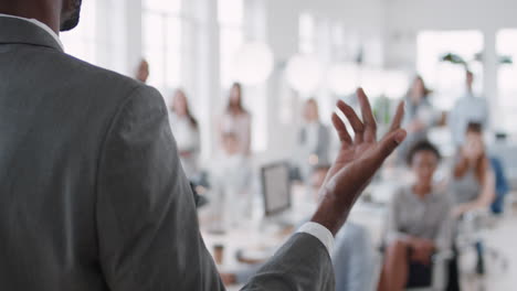 african american businessman team leader presenting in office meeting colleagues sharing leadership ideas in office training presentation seminar