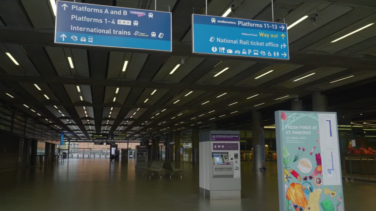 Left pan shot revealing empty St Pancras station and Thank you NHS sign, London, UK