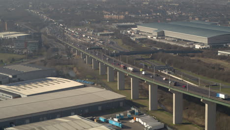 Aerial-view-of-congested-traffic-leaving-the-QE2-Dartford-crossing-on-the-River-Thames,-Kent---Essex-England