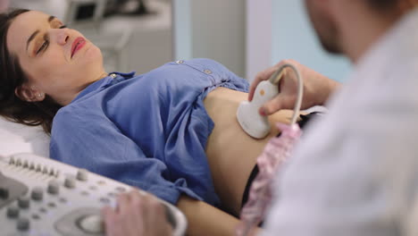 woman receiving abdominal ultrasound examination