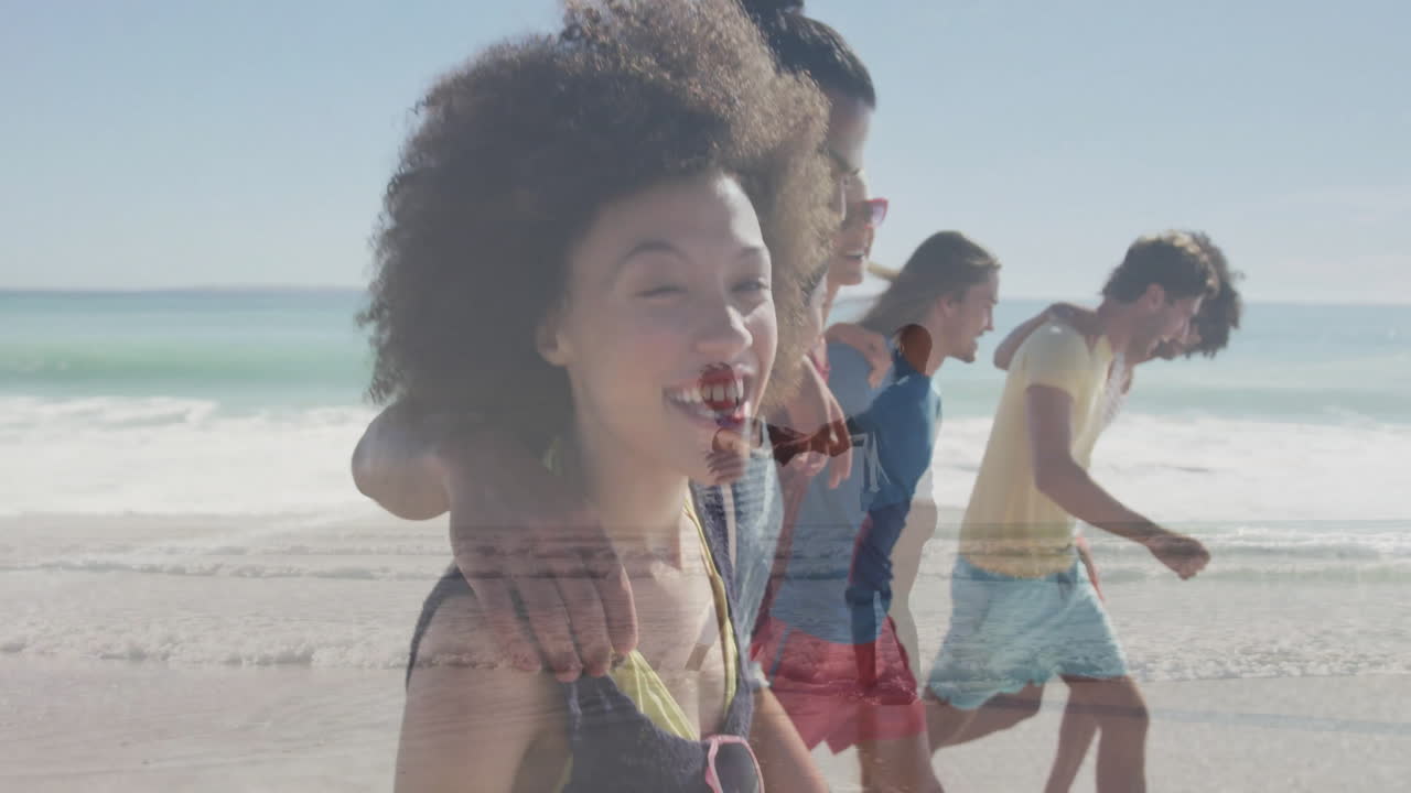 Walking along beach, group of friends enjoying sunny day together