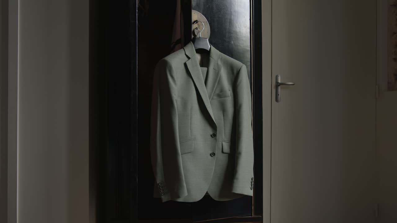 A Wedding Gray Coat Hanging Against The Cabinet Wall. Close-up Shot