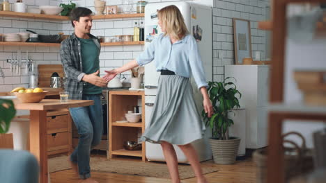 Love,-free-and-happy-couple-dancing-in-the-kitchen