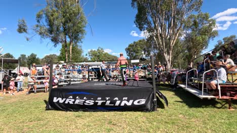 spectators watching a wrestling match outdoors