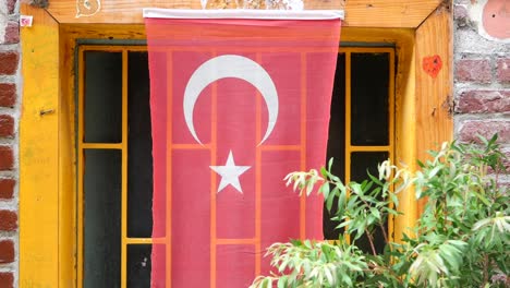 turkish flag hanging from a window