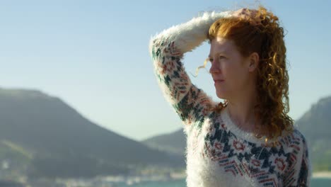 woman standing with hand on hair at countryside 4k