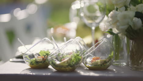 appetizers and salads on table for family dinner in nature finger buffet in blooming garden