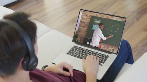 Animation-of-asian-boy-in-headphones-having-online-lessons-on-laptop-at-home