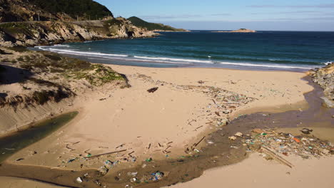 Contaminated-dry-riverbed-and-river-mount-on-tropical-beach-in-Vietnam,-aerial