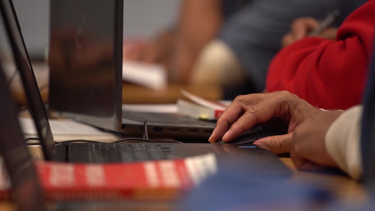 african american prisoner inmate in prison classroom on computer closer up hand 4k
