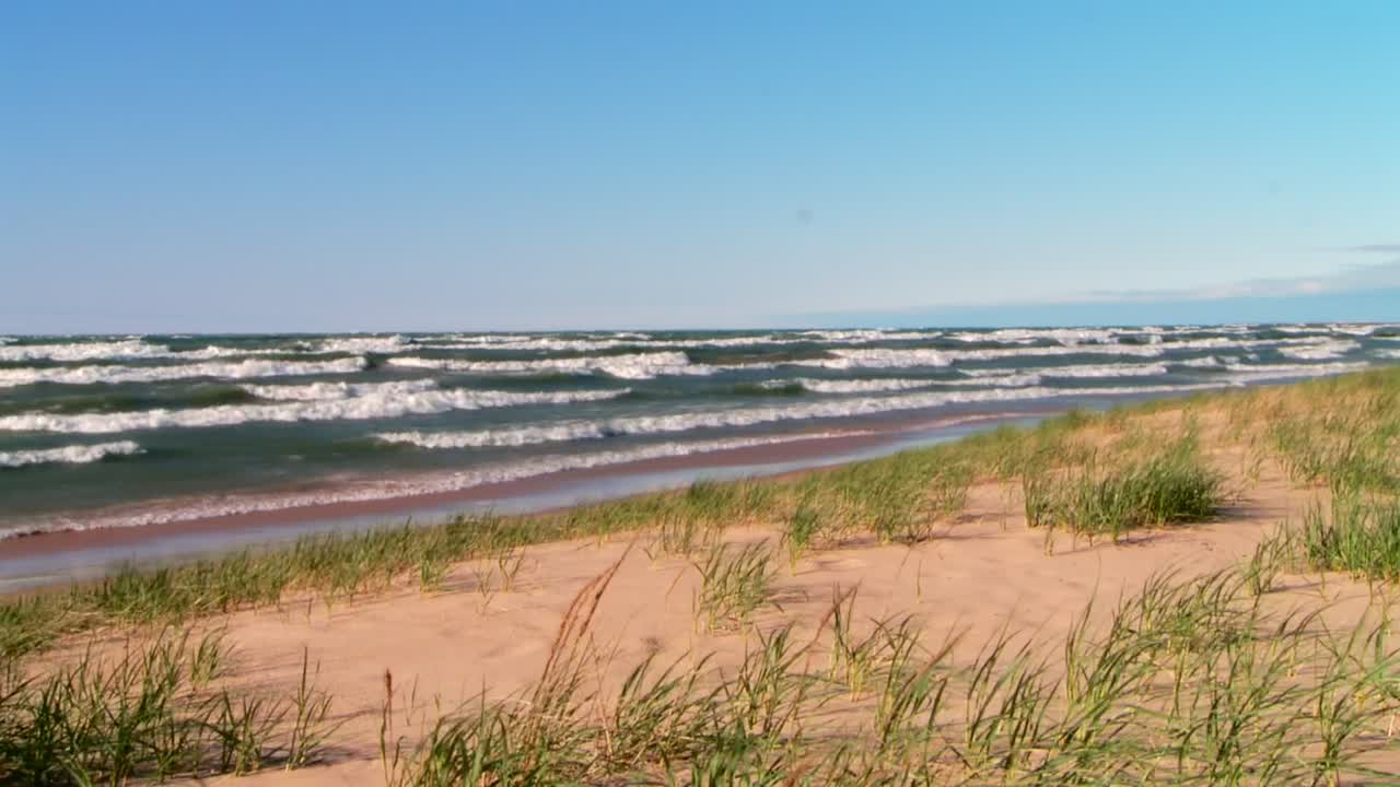 Beach scene with waves and dunes
