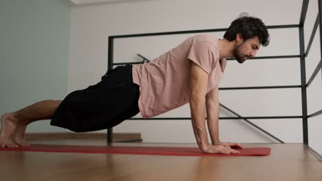 young skinny man doing push ups at home