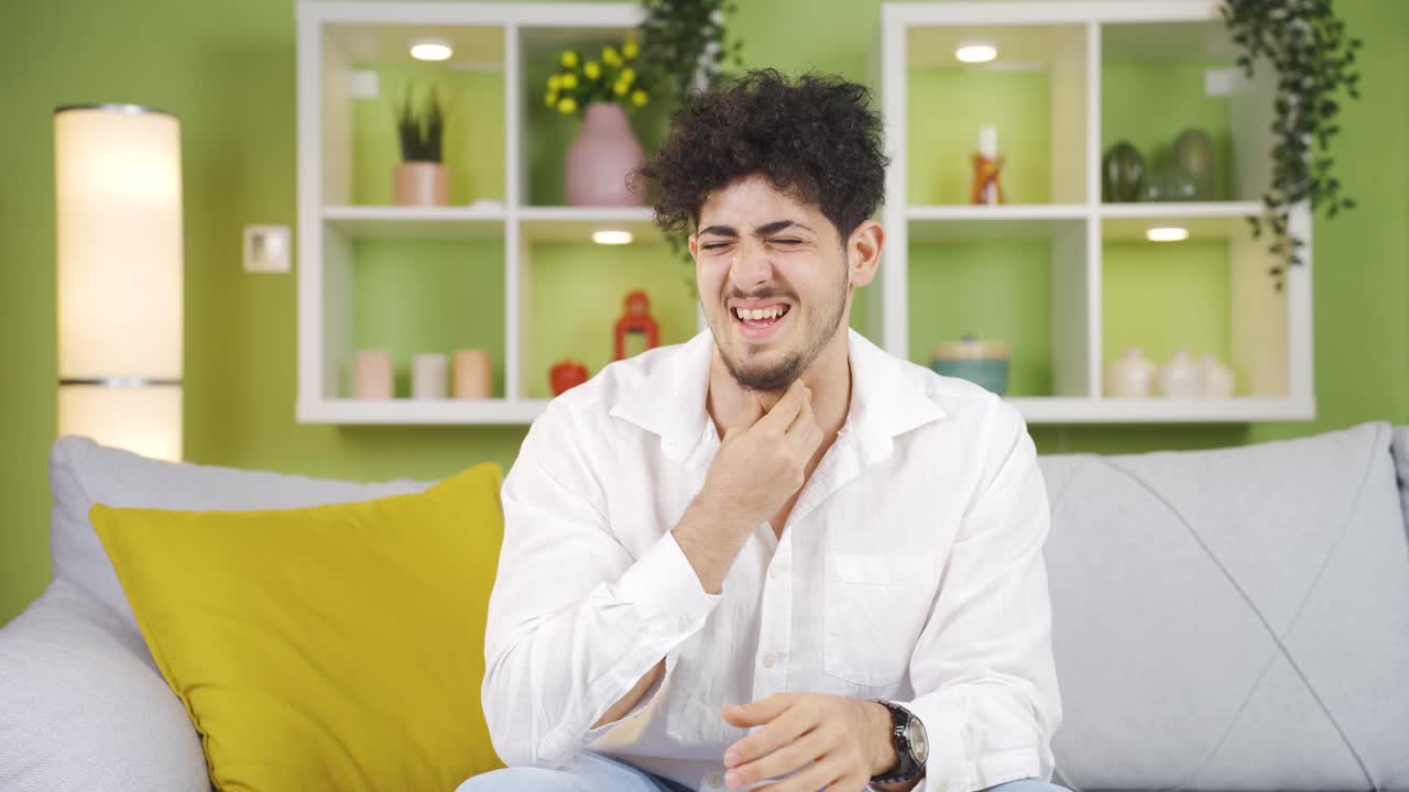 Young man coughing.