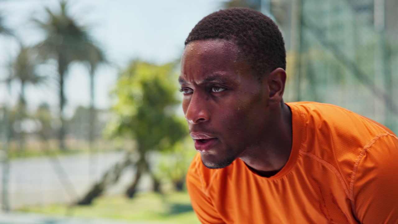 Close-up of a Sweating Male Athlete Catching His Breath Outdoors