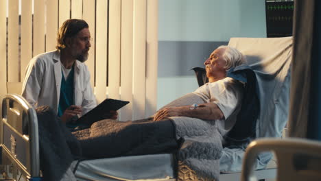 doctor discussing with senior patient in hospital