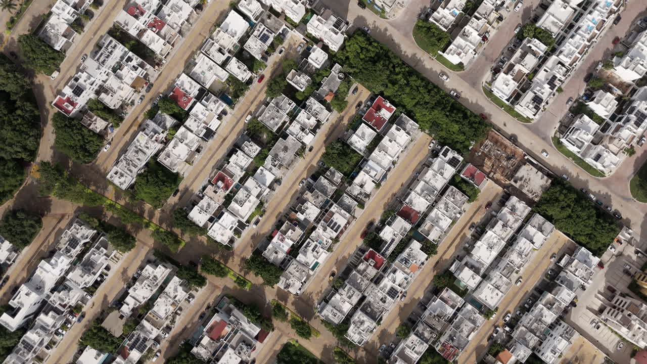 Orbital zenith drone shot of a gated community neighborhood in Cancun Mexico on a sunny day