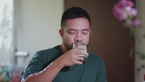 Man Drinking a Green Smoothie